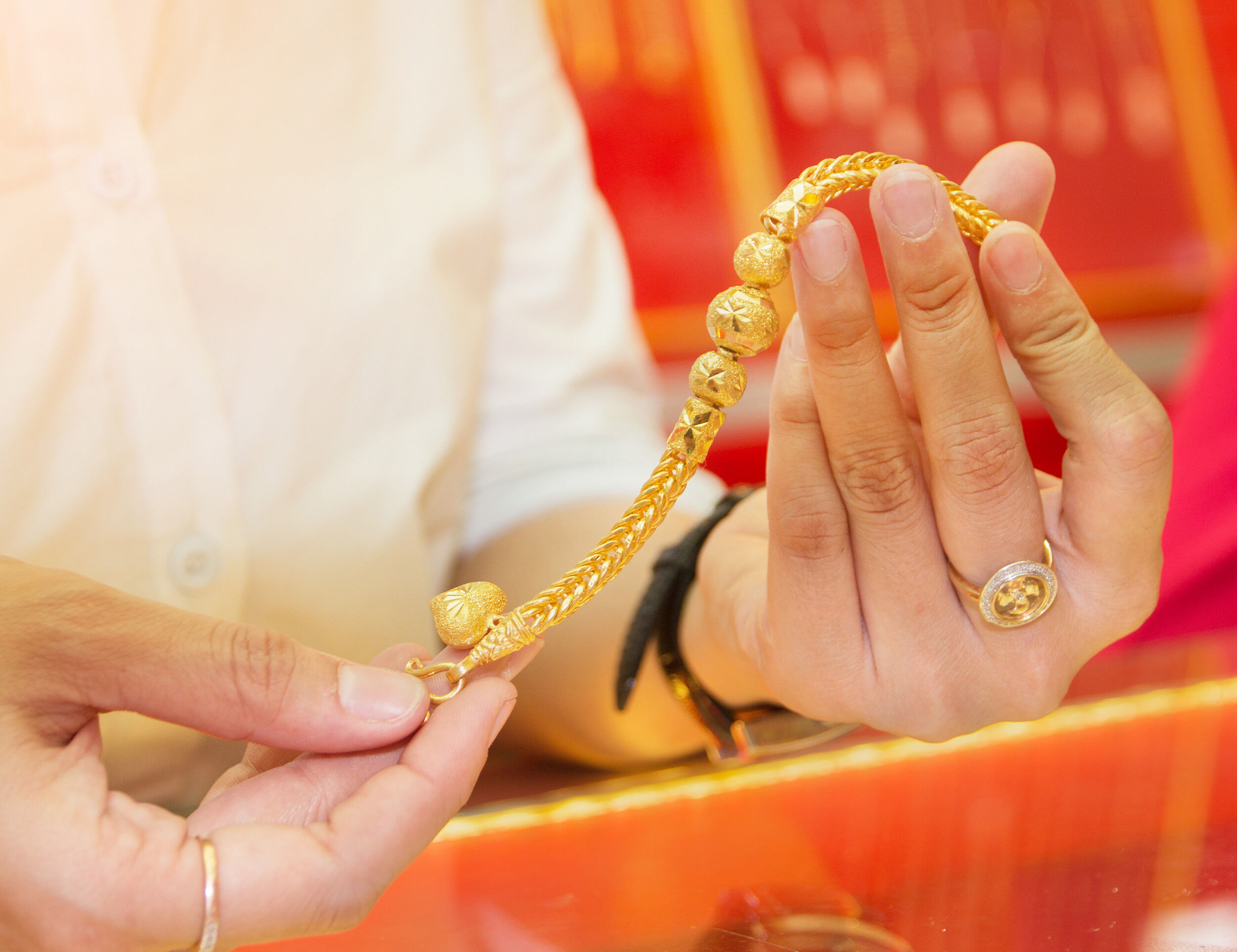 Gold chain held in hand symbolizing prosperity and tradition